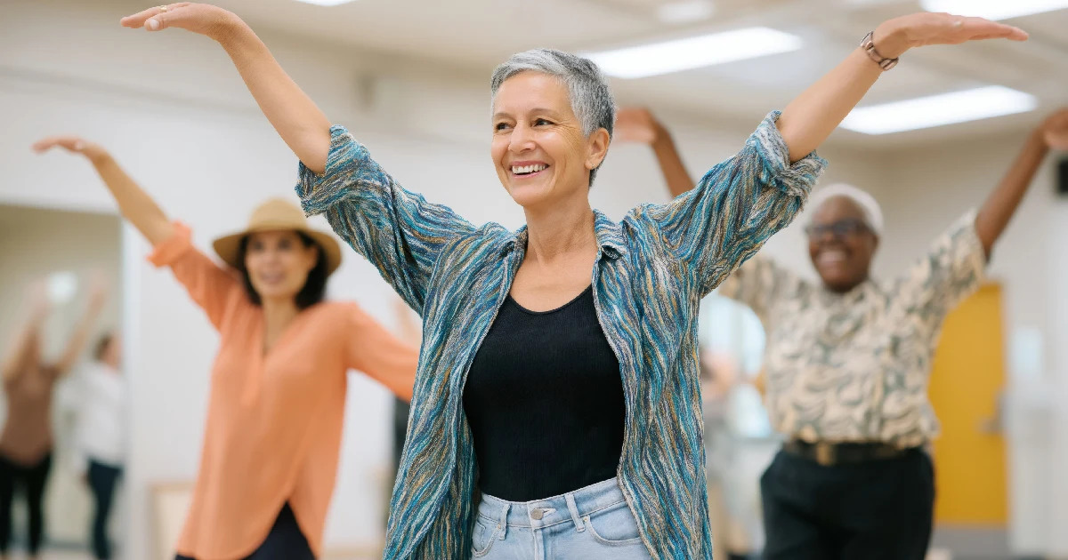 Smiling older adults participating in a dancemovement therapy session in Lafayette, CO
